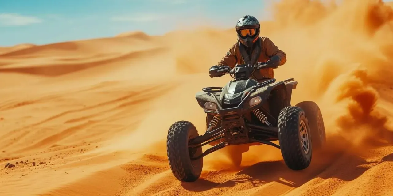 Quad bike rider kicking up sand on the dunes near Agadir, Morocco